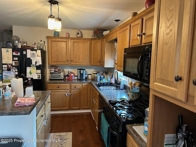 85 Cranberry Ter, Duryea, PA 18642 - kitchen featuring black appliances, dark countertops, dark wood-style floors, pendant lighting, and brown cabinetry