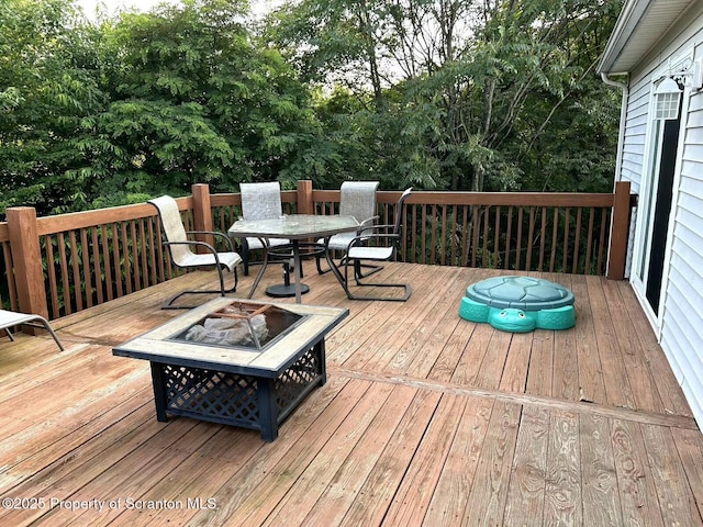 85 Cranberry Ter, Duryea, PA 18642 - wooden terrace featuring a fire pit, outdoor dining space, and view of wooded area