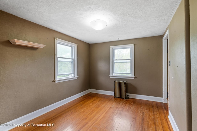 730 Chase Rd, Shavertown, PA 18708 - unfurnished room with radiator heating unit, wood-type flooring, a textured ceiling, and baseboards