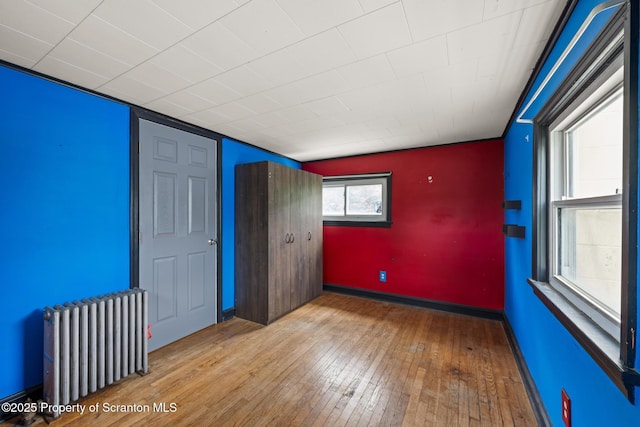 730 Chase Rd, Shavertown, PA 18708 - unfurnished bedroom with radiator, hardwood / wood-style floors, and baseboards