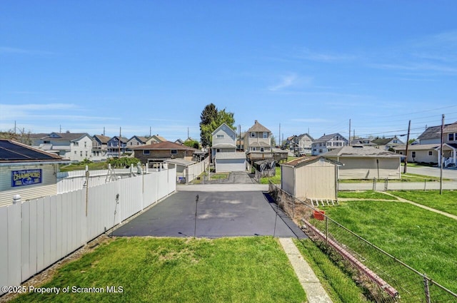 view of yard with a residential view and fence