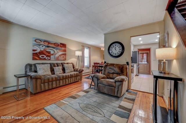 living room featuring wood-type flooring, recessed lighting, crown molding, and baseboard heating