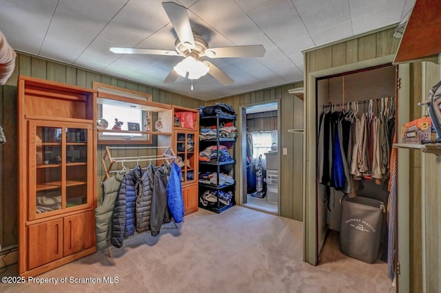 spacious closet with ceiling fan and carpet