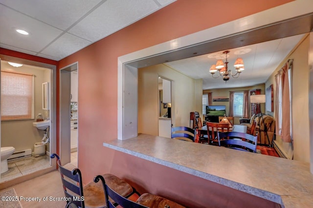 dining room featuring a baseboard radiator, a baseboard heating unit, and a notable chandelier