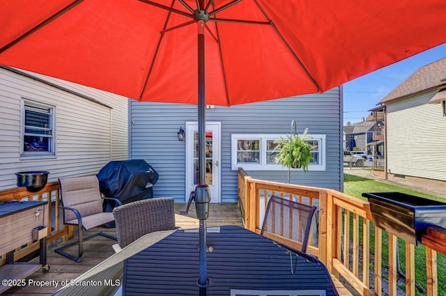 deck featuring outdoor dining area and area for grilling