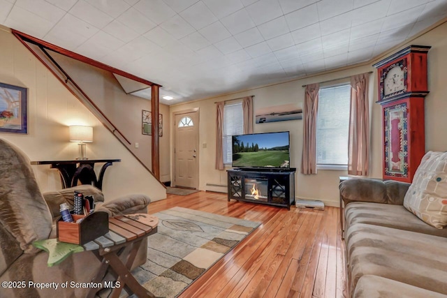 living area with a baseboard radiator and light wood-style flooring