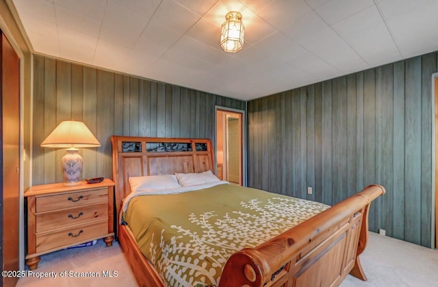 carpeted bedroom with wooden walls