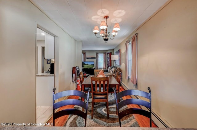dining space featuring an inviting chandelier and baseboard heating