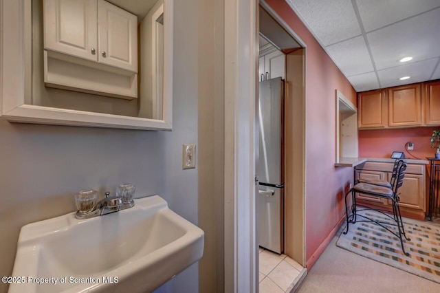 interior space featuring recessed lighting, tile patterned floors, and a sink