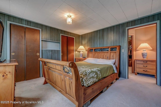 bedroom with carpet and wooden walls