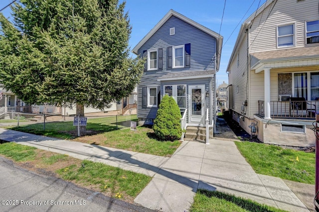 view of front of house with fence and a front yard