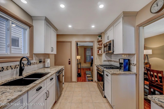 kitchen with a sink, backsplash, stainless steel appliances, and recessed lighting