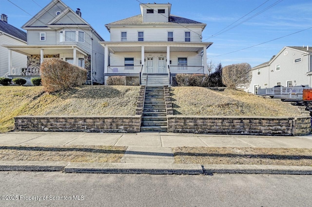 traditional style home featuring stairway and covered porch