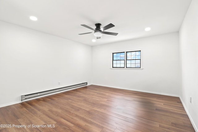 spare room featuring ceiling fan, a baseboard radiator, dark wood finished floors, and recessed lighting