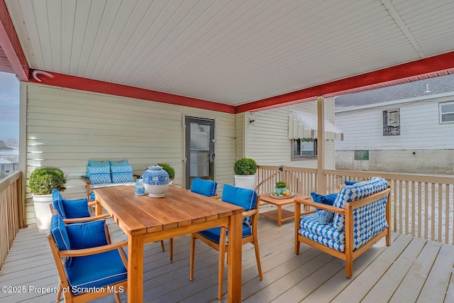 wooden deck with an outdoor hangout area and outdoor dining space