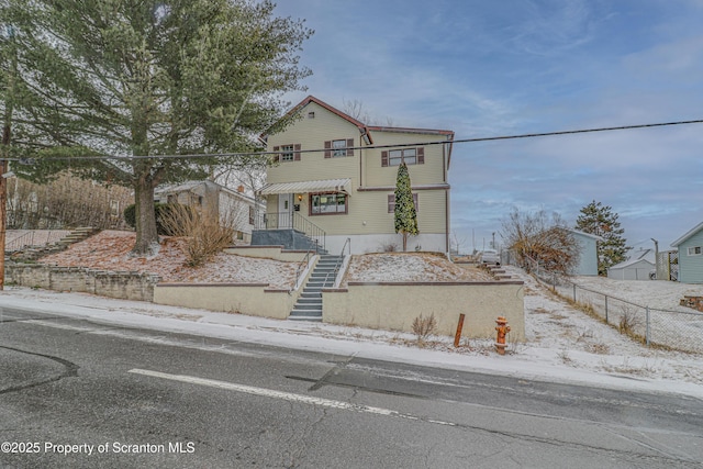 view of front of house with stairs and fence