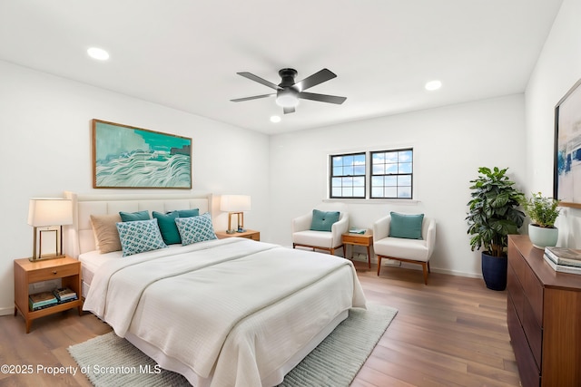 bedroom featuring baseboards, a ceiling fan, wood finished floors, and recessed lighting