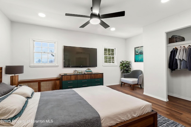 bedroom with a ceiling fan, recessed lighting, multiple windows, and wood finished floors