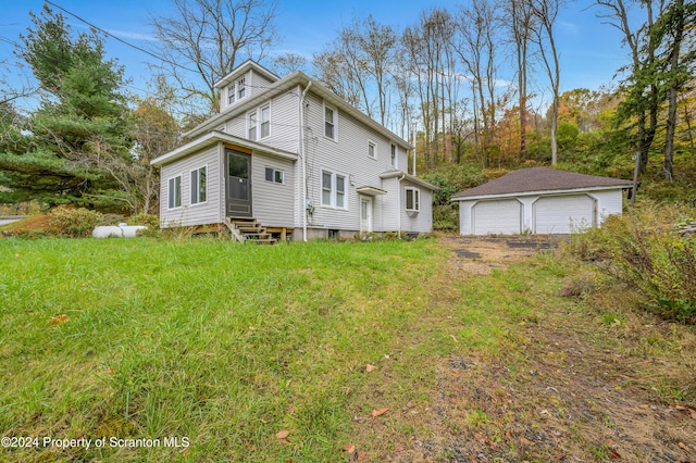 back of house featuring an outbuilding and a garage