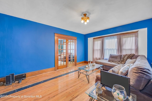 living room with hardwood / wood-style floors and french doors