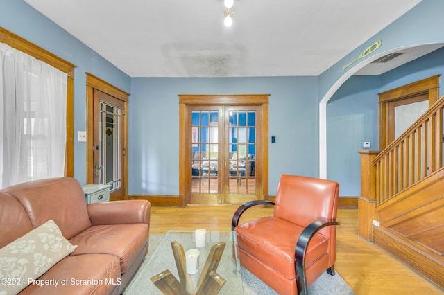 sitting room with french doors and light wood-type flooring