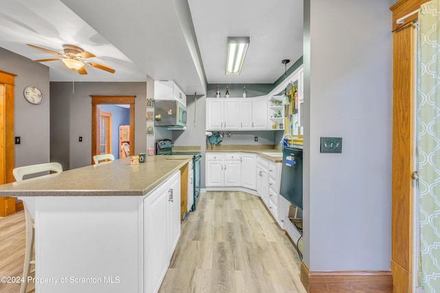 kitchen with white cabinetry, black electric range, light hardwood / wood-style flooring, a breakfast bar, and a kitchen island