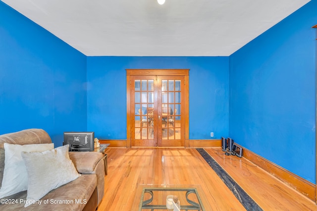 game room with french doors and hardwood / wood-style flooring