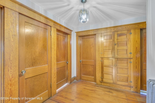 corridor with radiator and light wood-type flooring