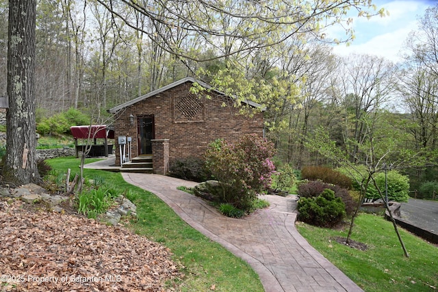 3511 Liberty Park Rd, Hallstead, PA 18822 - view of side of property featuring brick siding, a lawn, and a view of trees