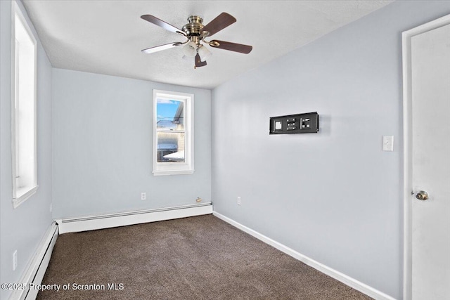 carpeted spare room featuring a baseboard radiator and ceiling fan