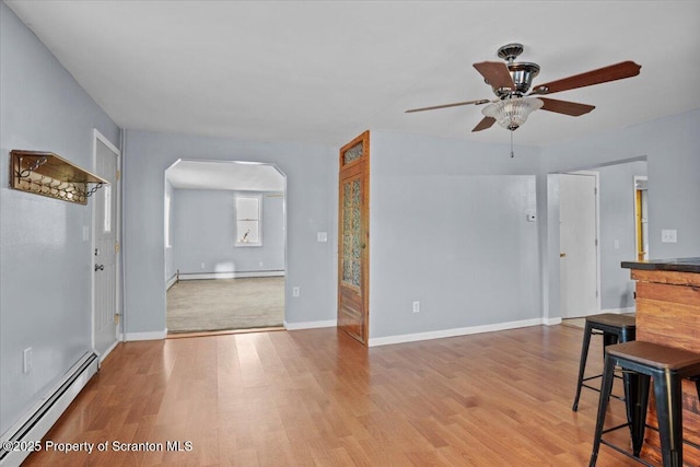 living room featuring ceiling fan, a baseboard radiator, and light hardwood / wood-style flooring