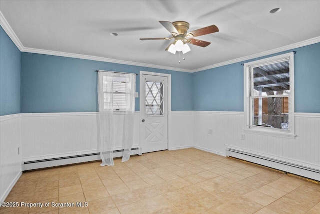 unfurnished room with ornamental molding, ceiling fan, and a baseboard heating unit