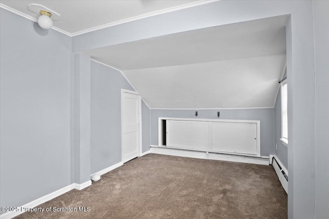 additional living space with a baseboard heating unit, carpet floors, and lofted ceiling