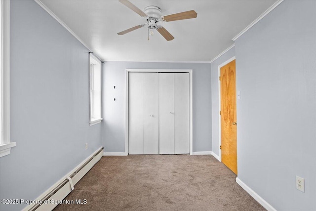 unfurnished bedroom featuring crown molding, a baseboard radiator, a closet, carpet, and ceiling fan