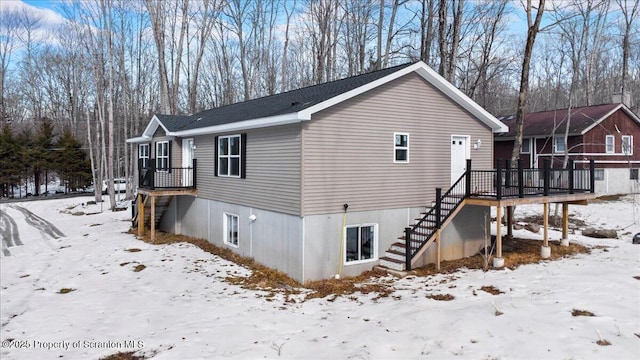 snow covered property featuring a deck