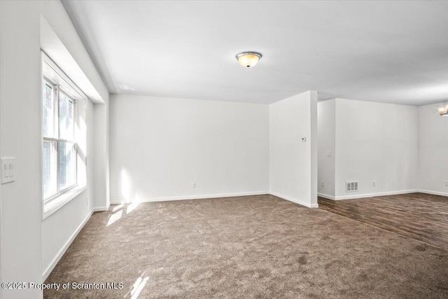 empty room with carpet and a chandelier