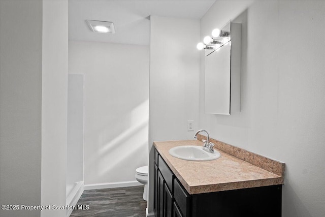 bathroom with vanity, hardwood / wood-style floors, and toilet