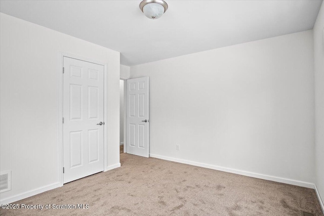 empty room with light colored carpet