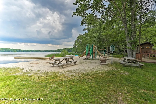 view of play area with a water view and a yard