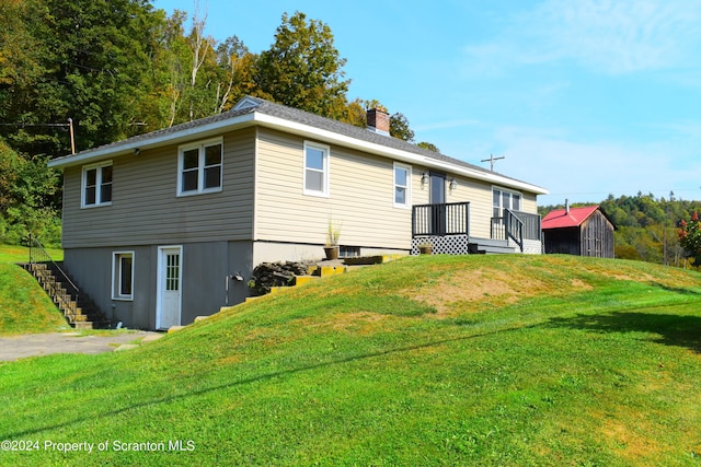 back of house featuring a yard and a deck