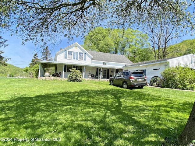 view of front facade with a front lawn and covered porch