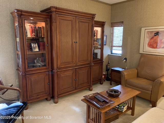 living area featuring crown molding