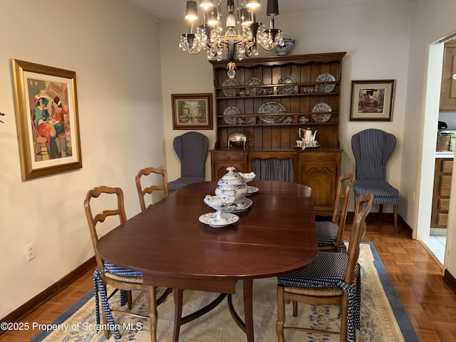 dining space with a chandelier and dark parquet floors