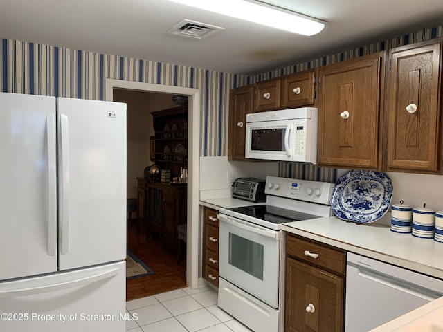 kitchen with light tile patterned flooring and white appliances