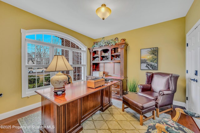 office with light wood-style flooring and baseboards