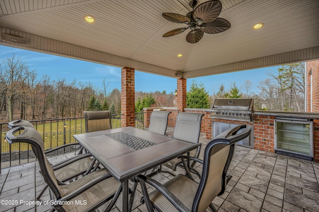 view of patio / terrace featuring outdoor dining area, a ceiling fan, and area for grilling