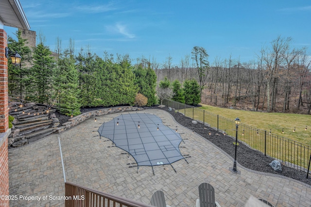 view of patio with a fenced in pool and fence