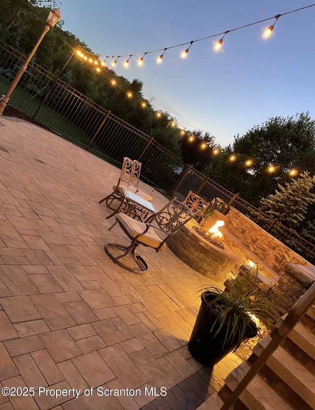 view of patio / terrace with fence and a fire pit
