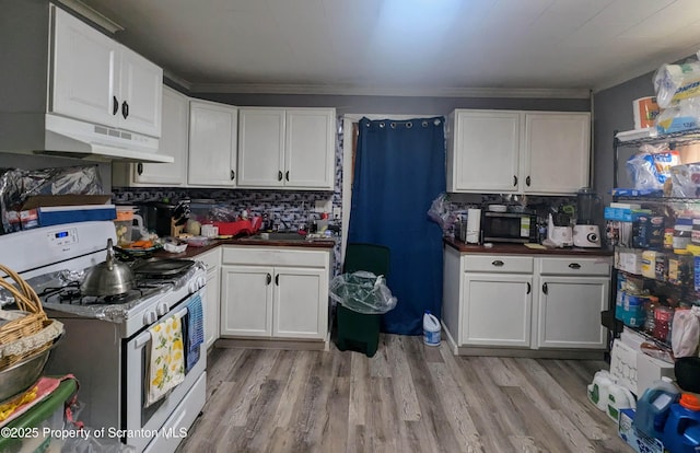 26-28 Glinko St, Scranton, PA 18504 - kitchen with gas range gas stove, under cabinet range hood, white cabinetry, light wood-style flooring, and crown molding