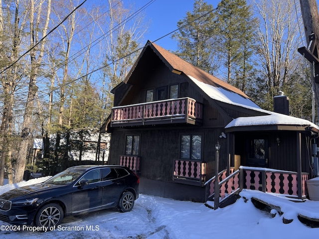 view of front of house with covered porch and a balcony